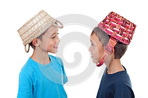 Twins playing with wicker baskets