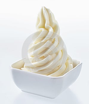 Twirled tower of frozen yogurt in a dish photo