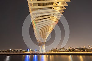 Twisted Bridge. Structure of architecture with lake or river, Dubai Downtown skyline, United Arab Emirates or UAE. Financial