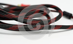 Twisted cable in a textile black sheath on a white background, hdmi adapter