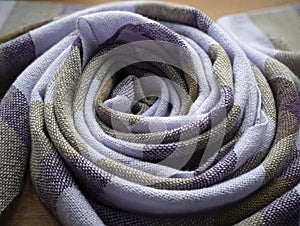 Twisted into a ring violet and olive scarf. Hand woven cashmere shawl. Concept of fashion, weaving and artisanship