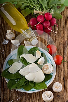 Twisted slovak cheese on plate with vegetable around