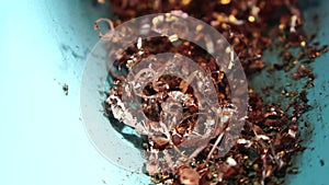 Twisted spiral copper shavings. Copper scrap materials recycling. chip waste after machining metal parts on a cnc lathe