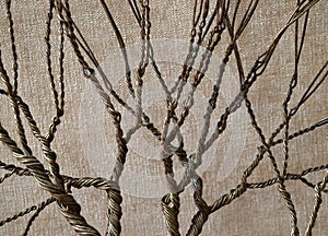 Twisted wire forming a tree with a textured background