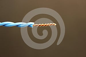 Twisting an electrical wire on an isolated background. Cable for electrical wiring. Simple connection method