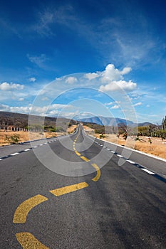 Twisting lane marking on road in desert