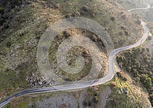 Twisty dangerous rural road in the mountains. Adventure outdoors.