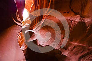 Twisty fiery curves of the Lower Canyon Antelope in Arizona illuminated by the meager rays of light carry tourists to