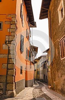 Twisty historical street with colourful houses in Ville del Monte - Italy.