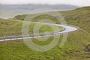 Twisty scenic road with green landscape in Faroe Islands