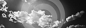 Twitter Header Image - Dramatic Clouds and Sky in Grainy Black and White with Sun Flare