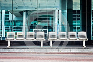 Two 4-seat bus waiting benchs at a modern bus stop station.