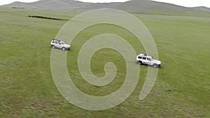 Two 4X4 Suv Cars Driving in The Treeless Vast Meadow