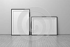 Two A4 blank empty frames vertical and horizontal standing on wooden floor i