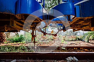 Two abandoned train cars linked by their links