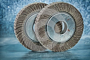 Two abrasive flap discs on metalic background