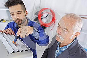 Two ac technicians repairing industrial air conditioning compressor