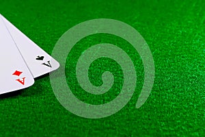 Two aces on the green felt casino table.