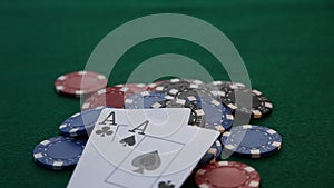 Two aces placed on a pile of poker chips.