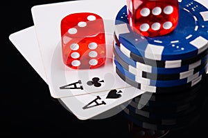Two aces, poker chips and red cubes, on a black background with mappings
