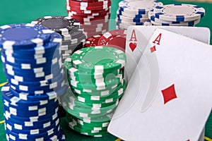 Two aces and poker chips on table close up. Gambling concept