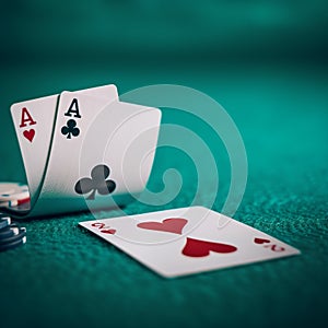 two aces poker hand on the green poker mat