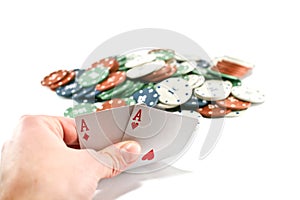 Two aces and stack of Casino Chips in background