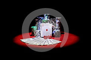 Two aces and Stack of gambling chips and dollars on red table
