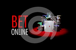 Two aces and Stack of gambling chips on red casino tabl