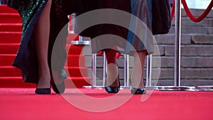 Two actresses are walking on the red carpet, close up