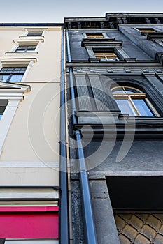 Two adjacent buildings, contrasting colors.