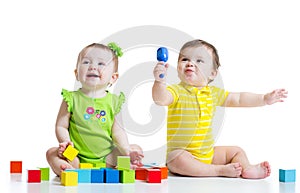 Two adorable babies playing with toys. Toddlers