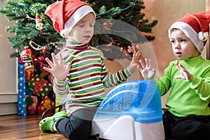 Two adorable boys playing with working humidifier, waiting for x-mas