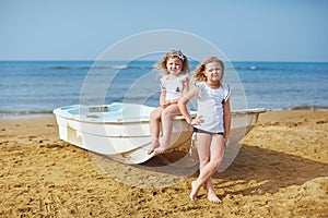 Two adorable sisters plying on sea side vacation resort hotel side photo