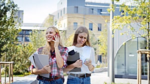 Two adult high school student girl spending time near campus