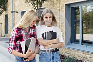 Two adult high school student girl spending time near campus