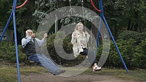 Two adult people swings in slowmotion