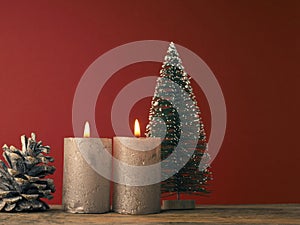 Two Advent candles burning on a red background