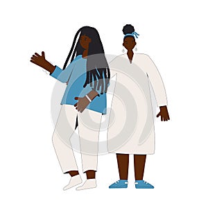 Two african american teenagers standing together isolated on white background. Young female friends wearing in casual clothes. Two