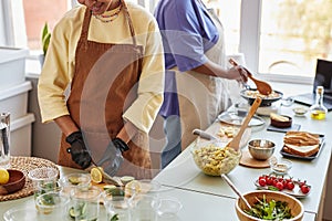 Two African American women doing food prep in kitchen