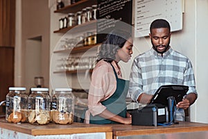 Two African entrepreneurs working behind their cafe counter