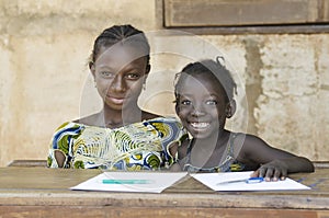 Two African Ethnicity Children Smiling Studying in a School Environment (Schooling Education Symbol)