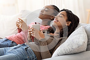 Two african women relaxing at home together