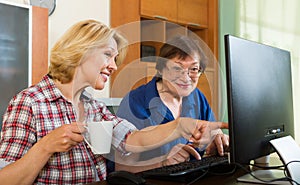 Two aged collegues with PC