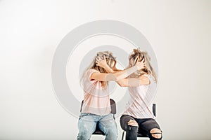 Two aggressive women arguing and shouting isolated on a white background