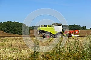 Two agricultural machines operate in the field, grain harvesting machines operate in the field, agricultural land