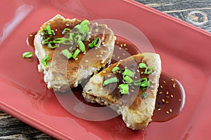 Two ahi tuna steak fillets with sauce