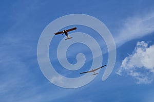 Two aircraft flying in the blue sky.