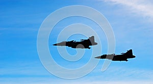 Two aircraft Jas 39 Gripen on blue sky