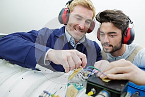 Two aircraft mechanics checking something